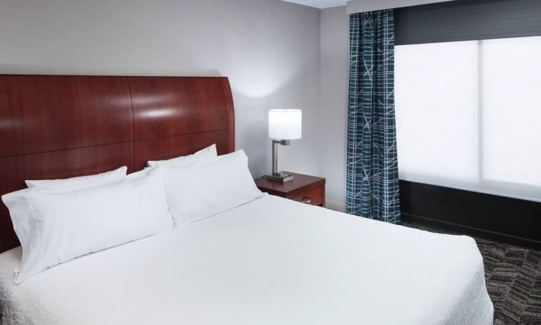 Comfortable king bedroom with natural light at Hilton Garden Inn Dallas/Allen.