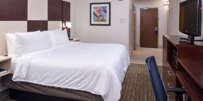 Delux king bed with TV and business desk at Holiday Inn Express Towson Baltimore N.