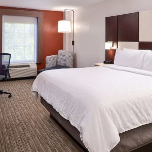 Spacious king bedroom with TV and work station at Holiday Inn Express Towson Baltimore N.