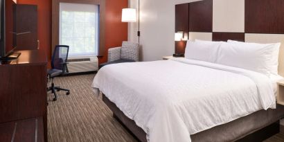 Spacious king bedroom with TV and work station at Holiday Inn Express Towson Baltimore N.