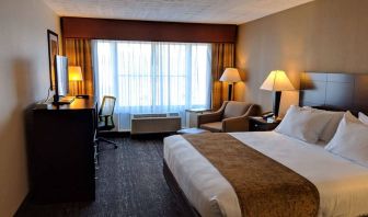 Double bed guest room at Best Western Braintree, including large window and armchair.