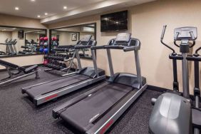 Hotel fitness center, with both weights and exercise machines for guests to use.