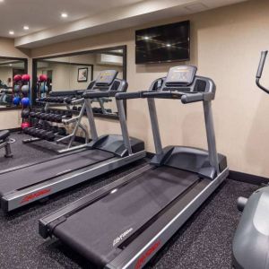 Hotel fitness center, with both weights and exercise machines for guests to use.