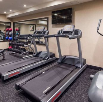 Hotel fitness center, with both weights and exercise machines for guests to use.