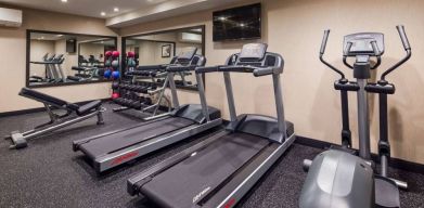 Hotel fitness center, with both weights and exercise machines for guests to use.