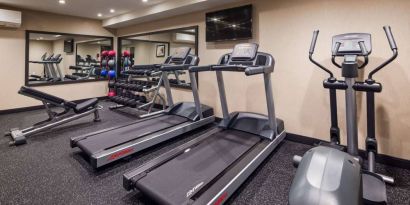 Hotel fitness center, with both weights and exercise machines for guests to use.