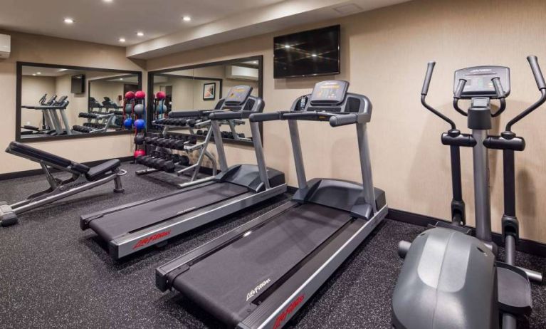 Hotel fitness center, with both weights and exercise machines for guests to use.