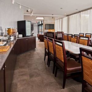 Best Western Braintree’s breakfast area has a hard floor, large windows, and plenty of tables.