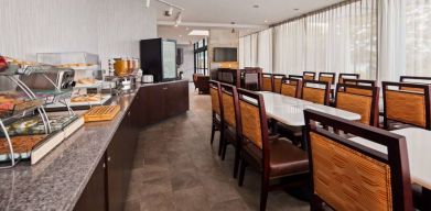 Best Western Braintree’s breakfast area has a hard floor, large windows, and plenty of tables.