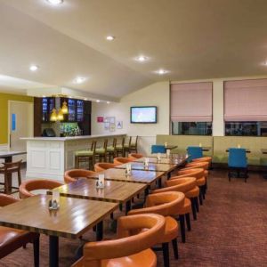 The on-site restaurant of Hilton Garden Inn Queens/JFK Airport has a bar and mostly small table seating.