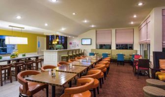 The on-site restaurant of Hilton Garden Inn Queens/JFK Airport has a bar and mostly small table seating.