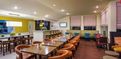 The on-site restaurant of Hilton Garden Inn Queens/JFK Airport has a bar and mostly small table seating.