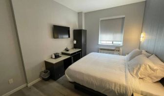 King Hotel Brooklyn guest room, featuring double bed and window with blind.