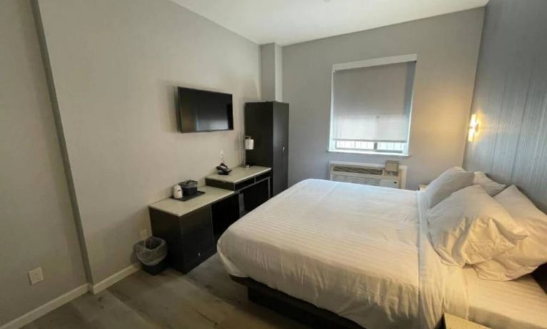 King Hotel Brooklyn guest room, featuring double bed and window with blind.