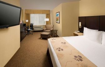 Spacious king bedroom with work station at Best Western Seattle Airport Hotel.