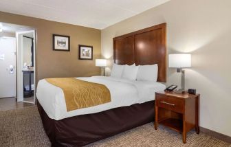 Spacious king bedroom with TV and work station at Comfort Inn Atlanta Airport.