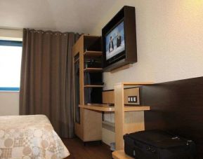 Delux king bed with TV and business desk at Eurohotel Airport Orly Rungis.