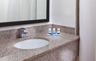 Private guest bathroom with shower at Fairfield Inn & Suites Houston Hobby Airport.