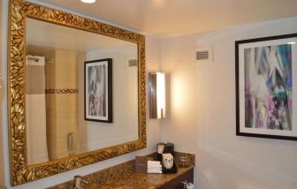 Private guest bathroom with shower at Pullman Miami Airport.