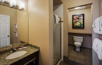 Private guest bathroom with shower at Ramada by Wyndham Vancouver Downtown.