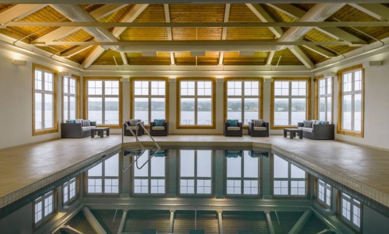 The hotel’s indoor pool has armchairs and sofas nearby.