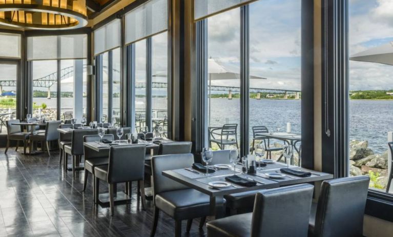 Rodd Miramichi River’s on-site restaurant has hard floors and tables with waterfront views.