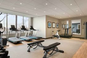 Fully equipped fitness center with window view at the Embassy Suites by Hilton Toronto Airport.