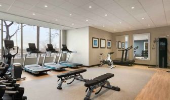 Fully equipped fitness center with window view at the Embassy Suites by Hilton Toronto Airport.