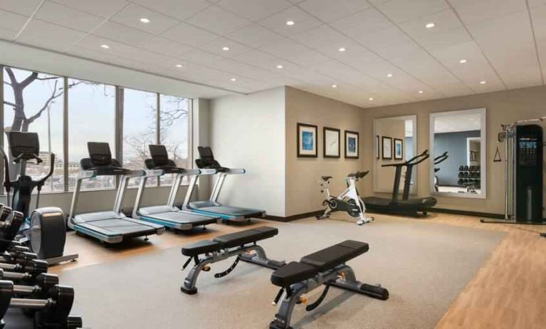 Fully equipped fitness center with window view at the Embassy Suites by Hilton Toronto Airport.