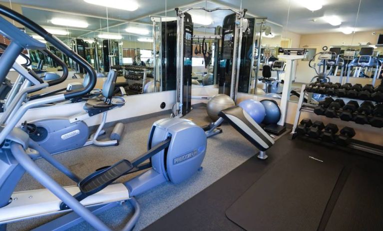 Candlewood Suites Boise’s fitness center has racks of weights and assorted exercise machines.