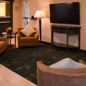 The hotel’s lounge in the lobby has armchairs, coffee tables, and a large widescreen TV.