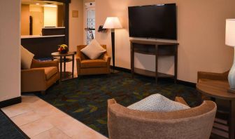 The hotel’s lounge in the lobby has armchairs, coffee tables, and a large widescreen TV.