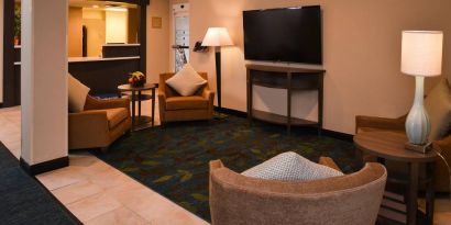 The hotel’s lounge in the lobby has armchairs, coffee tables, and a large widescreen TV.