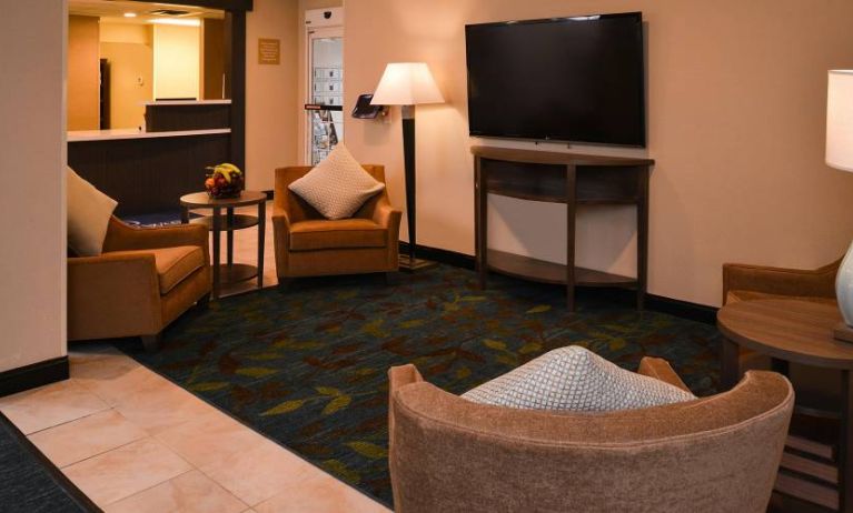 The hotel’s lounge in the lobby has armchairs, coffee tables, and a large widescreen TV.