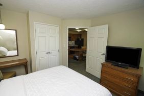 Candlewood Suites Meridian guest room featuring TV and a kitchenette area.