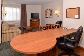 An in-room workspace at Candlewood Suites Meridian, including desk and chair.