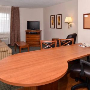 An in-room workspace at Candlewood Suites Meridian, including desk and chair.