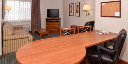 An in-room workspace at Candlewood Suites Meridian, including desk and chair.