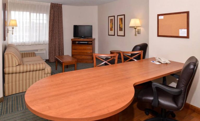 An in-room workspace at Candlewood Suites Meridian, including desk and chair.