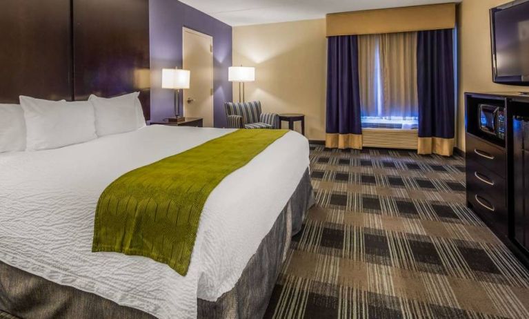 Best Western Hartford Hotel & Suites guest room, with armchair and TV.