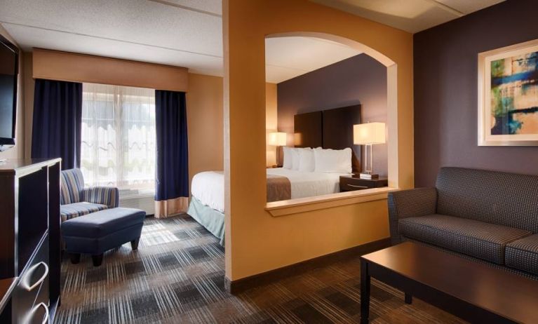 Best Western Hartford Hotel & Suites guest room, featuring bed, armchair, and sofa.