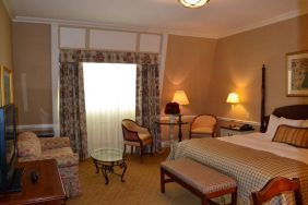 Guest room in The Wall Street Inn, including chairs and television.