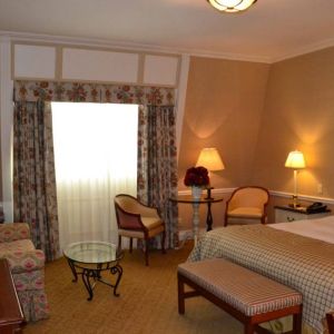 Guest room in The Wall Street Inn, including chairs and television.