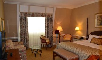 Guest room in The Wall Street Inn, including chairs and television.