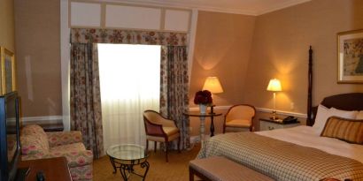 Guest room in The Wall Street Inn, including chairs and television.