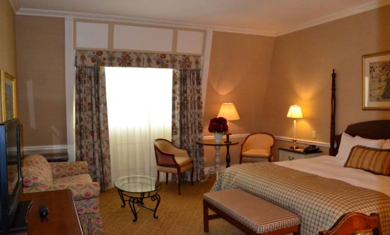 Guest room in The Wall Street Inn, including chairs and television.