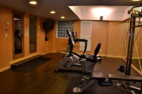 The hotel fitness center has exercise machines and a television.