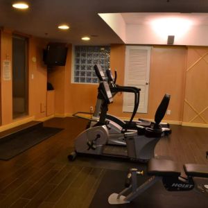 The hotel fitness center has exercise machines and a television.