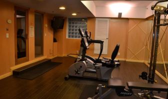 The hotel fitness center has exercise machines and a television.