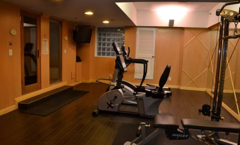 The hotel fitness center has exercise machines and a television.